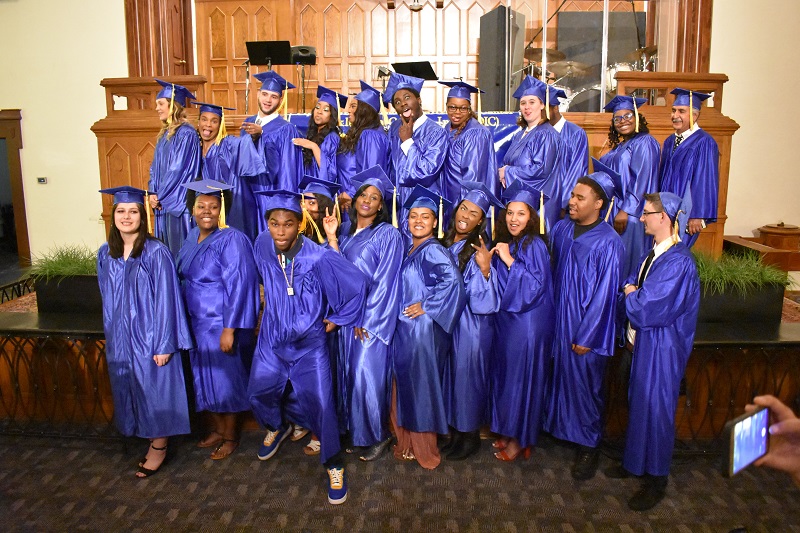 OIC graduates dressed in blue  cap and gown